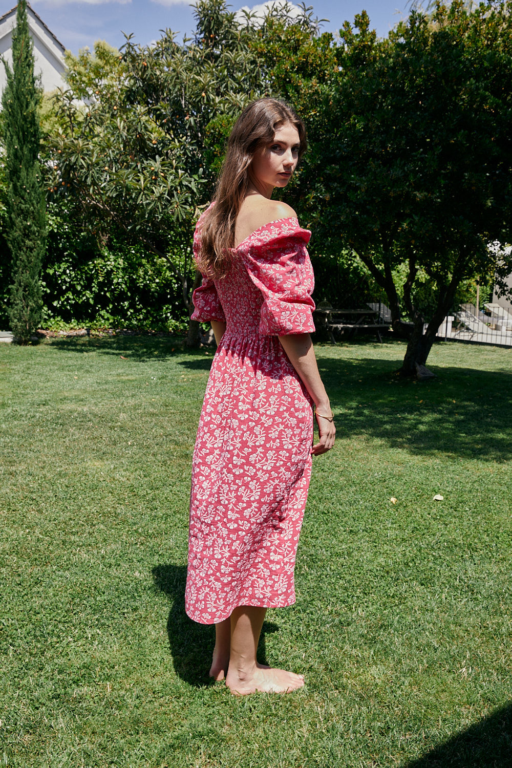 FRIDA dress with white flowers and fuchsia background